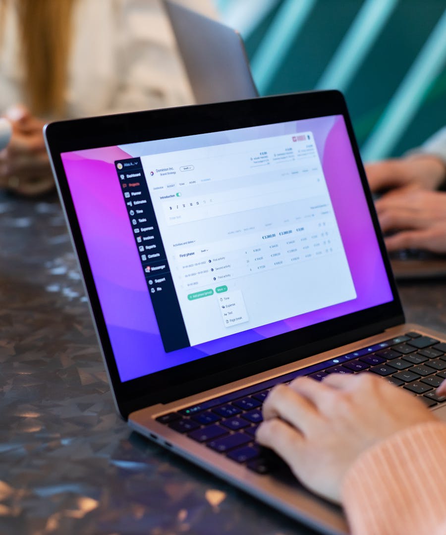 Business planning software displayed on a laptop during a collaborative work session.